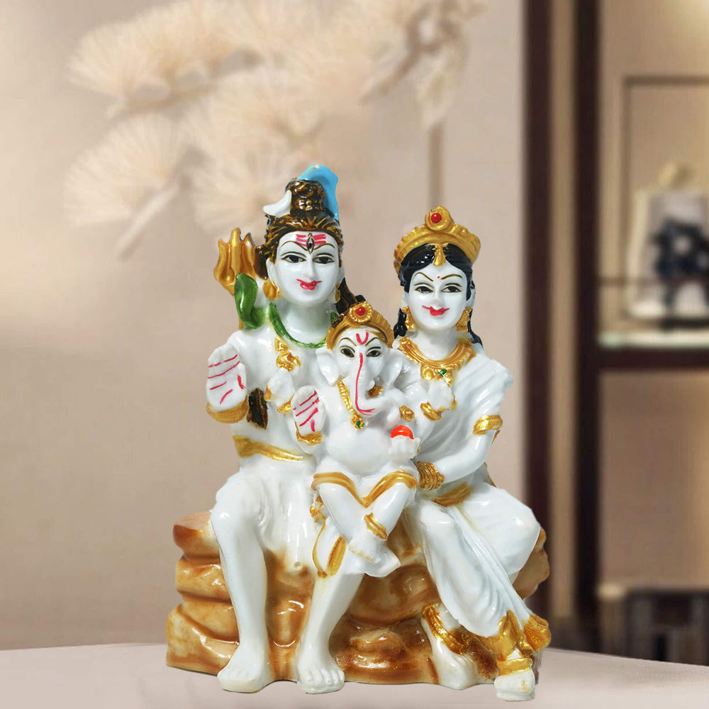 Decorative statue of three figures on a blurred background. Shiva Parivar Idol by Sudaya Gifts.
