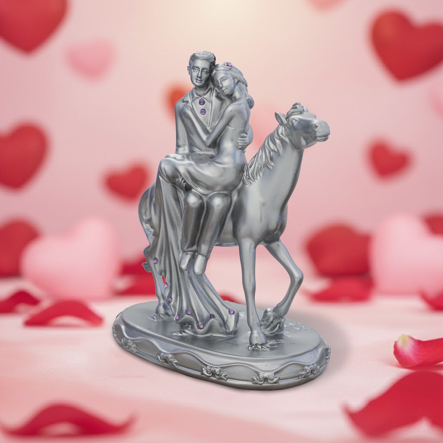 Statue of a couple on a horse with a heart-themed background