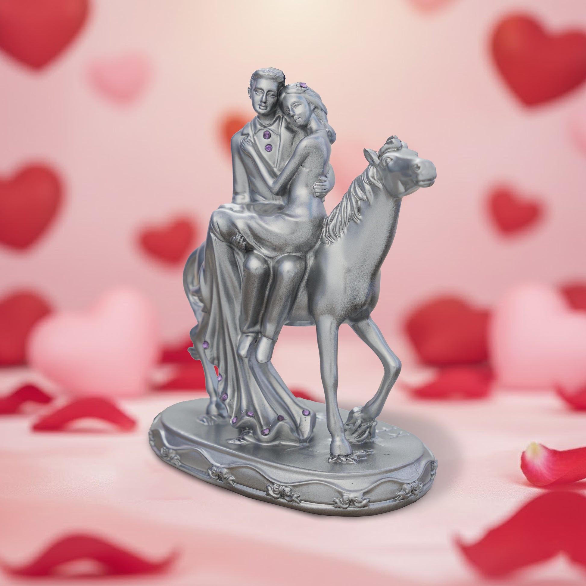 Statue of a couple on a horse with a heart-themed background